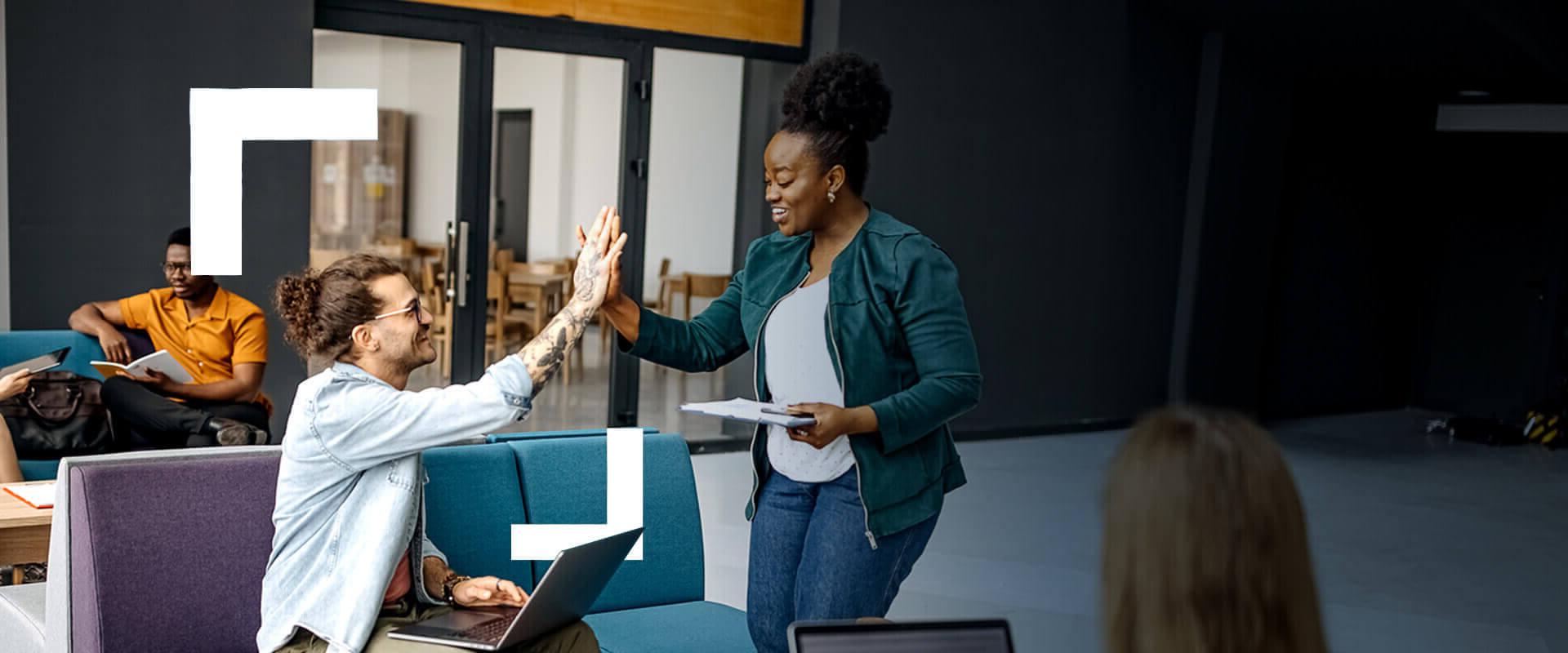 Co-workers give each other a high five